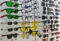 A large assortment of different glasses on a shelf in an optics store