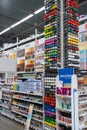 A large assortment of interior and exterior paints on the shelves in a building hypermarket. Minsk, Belarus, 2023