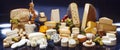 Large assortment of international cheese specialities on black background