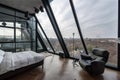 large attic room with floor-to-ceiling windows and view over the city