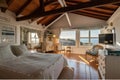 a large attic room with a view of the sea and sunsets