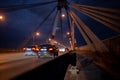 A large automobile bridge on which cars drive at night. Royalty Free Stock Photo