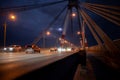 A large automobile bridge on which cars drive at night. Royalty Free Stock Photo