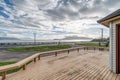 Large back deck wood dramatic sunset blue sky clouds green grass ocean Bay Bellingham lummi Royalty Free Stock Photo