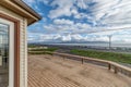 Large back deck wood dramatic sunset blue sky clouds green grass ocean Bay Bellingham lummi Royalty Free Stock Photo