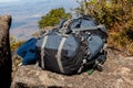 Large backpack over a rock in mountain landscape Royalty Free Stock Photo