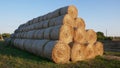 Large bales of hay are stacked for storage