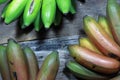 Large banana fruits on wooden background.