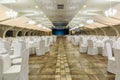 Large banquet hall decorated for social event with served tables and stage in background Royalty Free Stock Photo