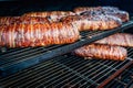 Large barbecue smoker grill at the park. Meat and bacon prepared in barbecue smoker