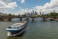 Large barge moving upstream in front of the skyline, Frankfurt, Germany
