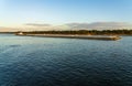 Large barge pushed down Mississippi river at dusk Royalty Free Stock Photo