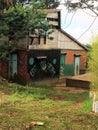 A barn with graffiti on it outside of a Haitian village