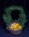 A large basket of fruit and Christmas balls. Crowned wreath of s Royalty Free Stock Photo