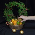 A large basket of fruit and Christmas balls. Crowned wreath of s Royalty Free Stock Photo