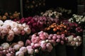 large baskets with peonies of different colors on the counter of a flower shop