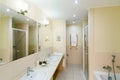 large bathroom of the hotel rooms, with a shower and a few washbasins Royalty Free Stock Photo