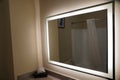 A large bathroom mirror with lights on the edges Royalty Free Stock Photo