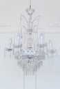 Large beautiful glass chandelier hanging on the ceiling Royalty Free Stock Photo