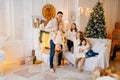 a large, beautiful and happy family in a room by the Christmas tree. Royalty Free Stock Photo