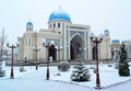 A large beautiful mosque with a large dome in winter.