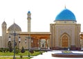 A large beautiful mosque with a large minaret and four small.