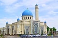 A large beautiful mosque with a large minaret and four small.