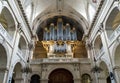 A large beautiful music organ inside of the Dome des Invalides cathedral, Paris