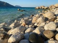 Large beautiful natural round stones and pebbles washed by water on the seashore or ocean against the backdrop of mountains