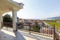 Large beautiful rich spacious veranda in the cottage with views of the mountains and the sea. Veranda with beautiful white tiles.