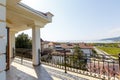 Large beautiful rich spacious veranda in the cottage with views of the mountains and the sea. Veranda with beautiful white tiles.