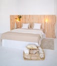 Large bed with beige pillowcases and white pillows
