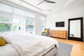 A large bedroom with yellow accents around the room.