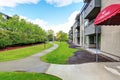 Large beige apartment building with three floors and balconies. Well kept lawn Royalty Free Stock Photo