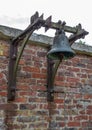 Large bell on a brick wall Royalty Free Stock Photo
