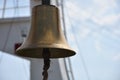 A big bell made of bronze on the ship`s deck with sky and clouds Royalty Free Stock Photo