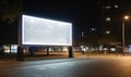 Large Billboard Illuminating a City Street at Night Royalty Free Stock Photo