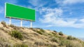 A large billboard with its advertising space in chroma key for use by designers, on top of an embankment with bushes, under a Royalty Free Stock Photo