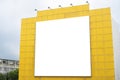 A large billboard is mounted on a backdrop with five spotlights on a yellow background Royalty Free Stock Photo