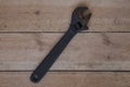 Large black adjustable spanner with traces of operation