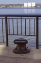 Large black bollard on a concrete dock