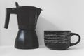 Large black coffee mug and coffee pot