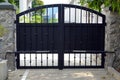 Large black gate with automatic door opening and closing system.