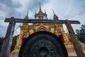 Large black gong in front of gold temple