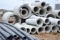 Large black plastic and concrete stone cement sewer plumbing pipes for the construction of water pipes or sewers at a construction Royalty Free Stock Photo