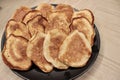 on a large black plate, small sweet pancakes are baked for tea for breakfast Royalty Free Stock Photo