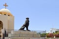 large black stone lion against the background of an Egyptian orthodox Christian white church with crosses and domes for prayers.