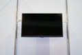 A large black TV screen on a white wall