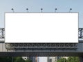 Large blank billboard on a metal bridge structure against a clear blue sky Royalty Free Stock Photo