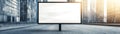 A large blank billboard stands in an urban setting, surrounded by modern buildings and soft sunlight, ready for advertisement Royalty Free Stock Photo